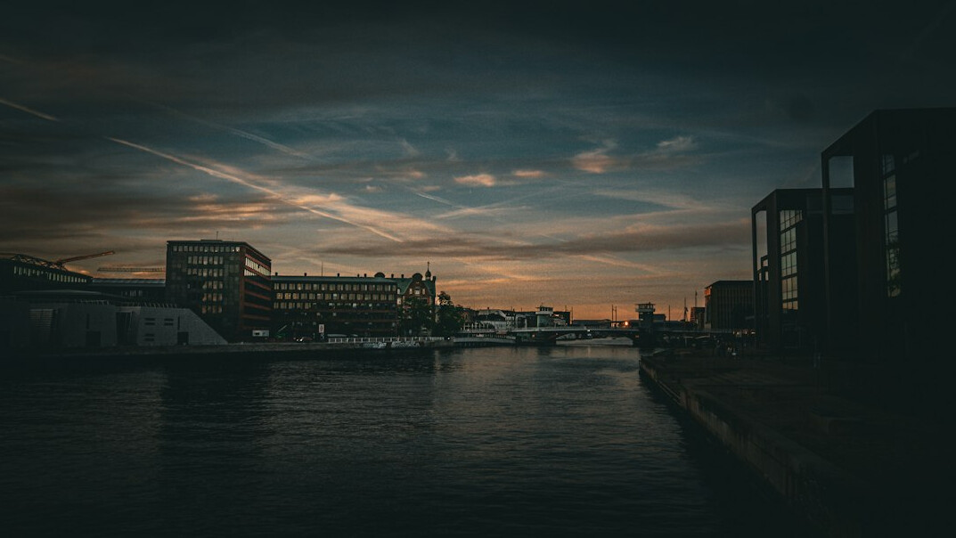 Modern harbor architecture beside calm water in a Danish city