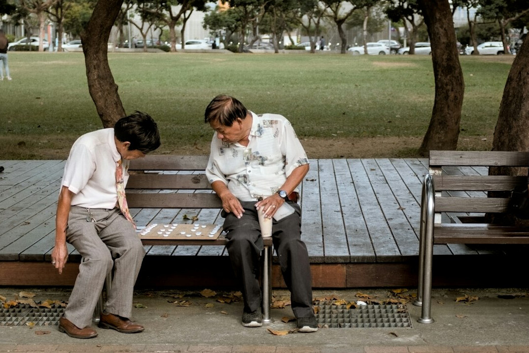 man sharing story on bench