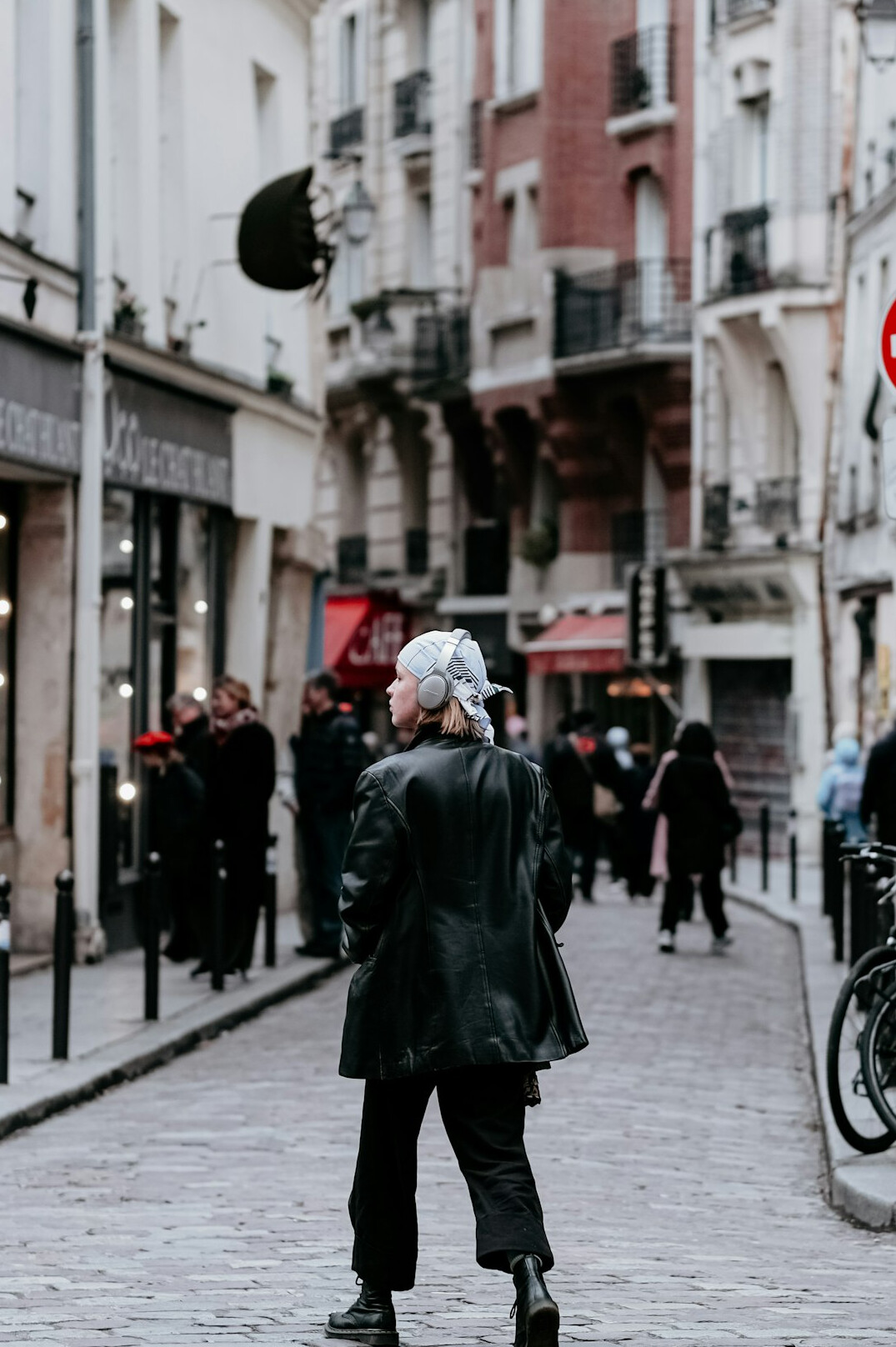 elderly woman on cobblestone street