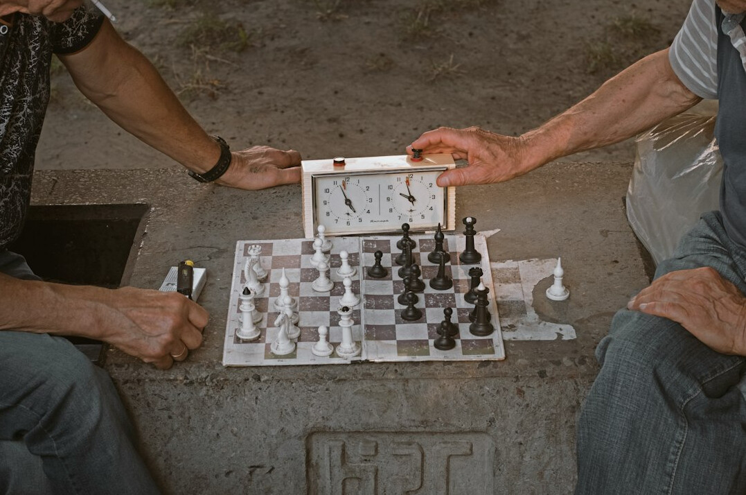 elderly people playing chess